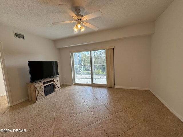 unfurnished living room featuring light tile patterned floors, a textured ceiling, and ceiling fan