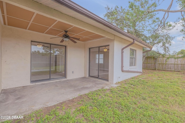 exterior space with a patio area, ceiling fan, and a lawn