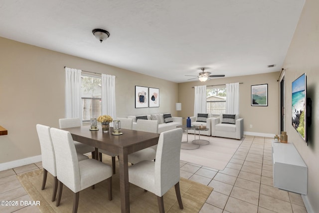 tiled dining area featuring ceiling fan