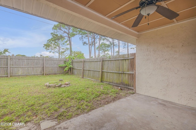 view of yard with a patio and ceiling fan