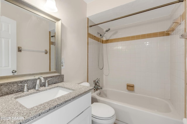 full bathroom with vanity, toilet, and tiled shower / bath combo