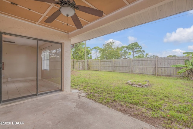 view of yard with a patio and ceiling fan