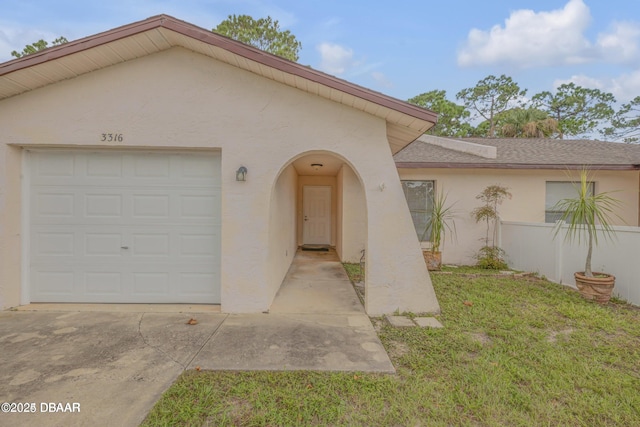 view of front of house with a garage and a front lawn