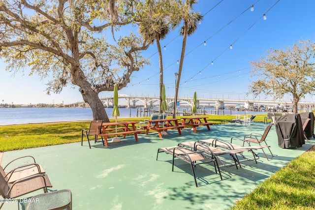 view of property's community featuring a water view and a lawn