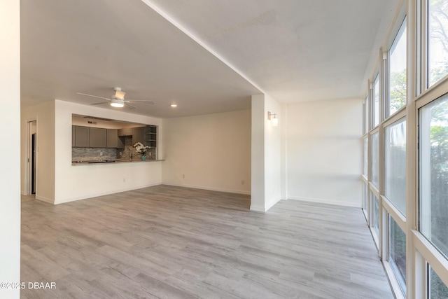 interior space with recessed lighting, ceiling fan, baseboards, and light wood-style floors