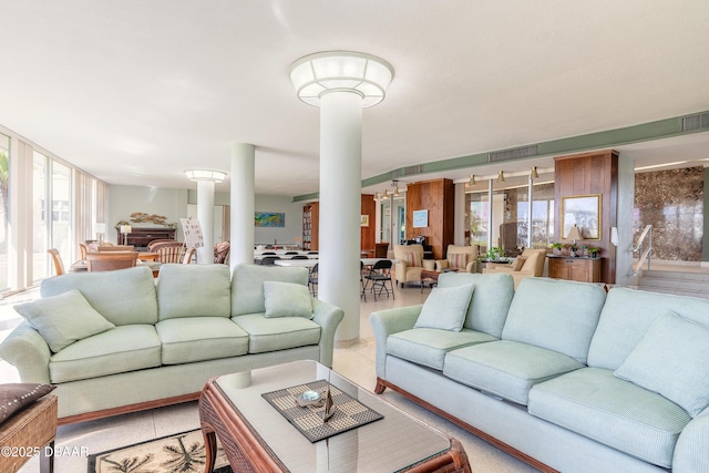 living area with visible vents and ornate columns