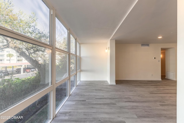 unfurnished sunroom with visible vents