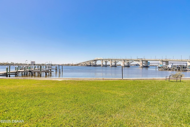 dock area featuring a yard and a water view