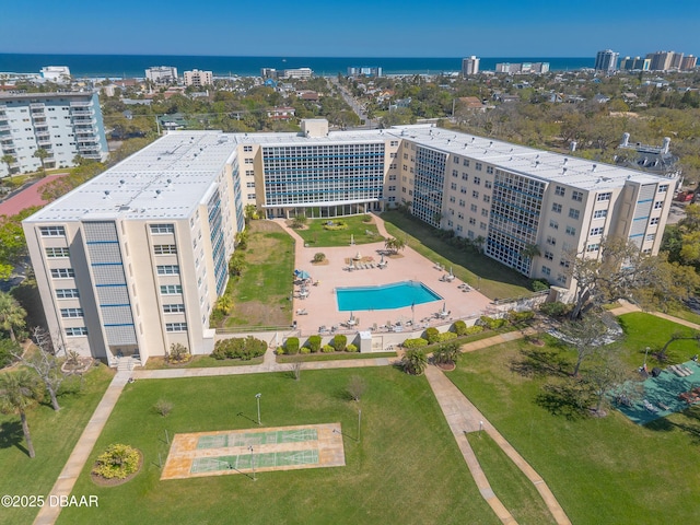 birds eye view of property featuring a water view and a view of city