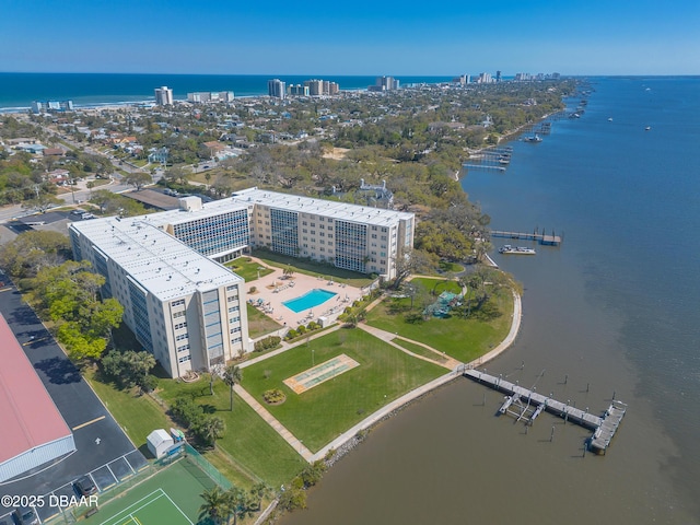 drone / aerial view with a city view and a water view