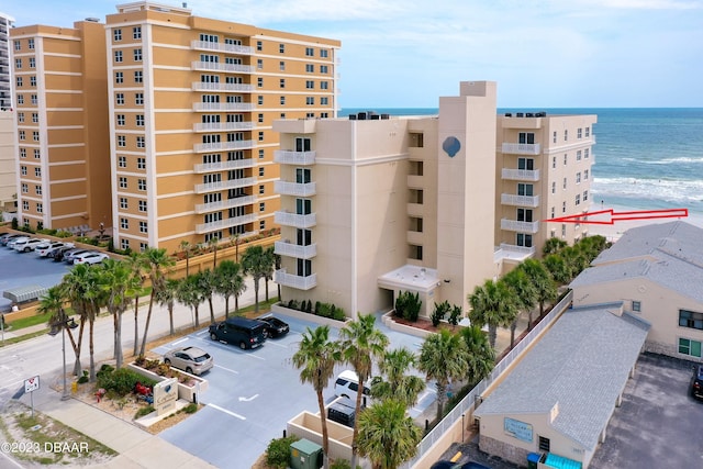 3801 S Atlantic Ave Unit 303, Daytona Beach Shores, FL 32118 - view of apartment building / complex with uncovered parking and a water view