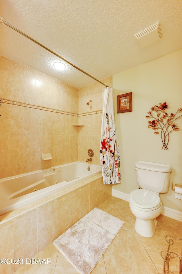 3801 S Atlantic Ave Unit 303, Daytona Beach Shores, FL 32118 - bathroom with tile patterned floors, a combined bath / shower with jetted tub, toilet, a textured ceiling, and baseboards