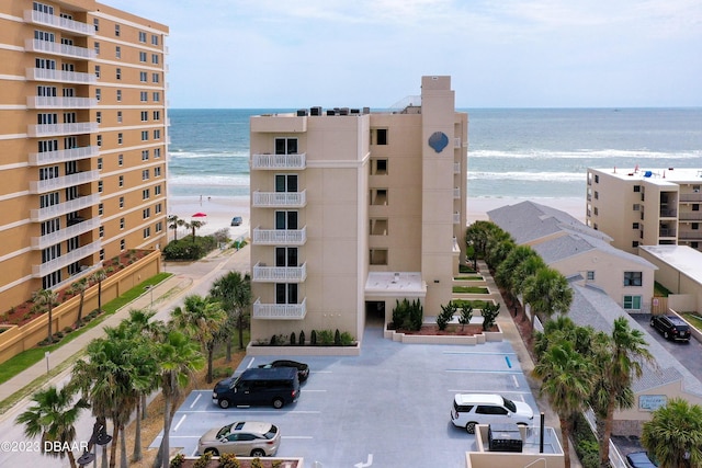 3801 S Atlantic Ave Unit 303, Daytona Beach Shores, FL 32118 - view of apartment building / complex featuring uncovered parking and view of water and beach