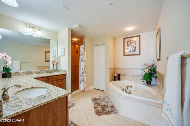 3801 S Atlantic Ave Unit 303, Daytona Beach Shores, FL 32118 - bathroom with vanity, a bath, a stall shower, tile patterned floors, and a textured ceiling