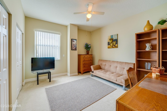 3801 S Atlantic Ave Unit 303, Daytona Beach Shores, FL 32118 - living area with light carpet, ceiling fan, and baseboards