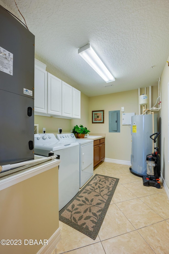 3801 S Atlantic Ave Unit 303, Daytona Beach Shores, FL 32118 - washroom with cabinet space, washer and clothes dryer, electric water heater, electric panel, and a textured ceiling