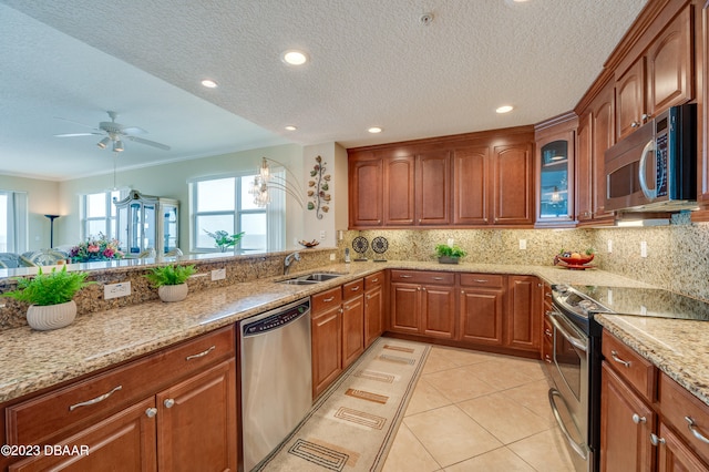 kitchen featuring a textured ceiling, stainless steel appliances, sink, and backsplash