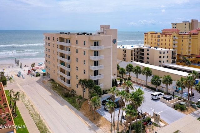3801 S Atlantic Ave Unit 303, Daytona Beach Shores, FL 32118 - view of apartment building / complex featuring uncovered parking and a water view
