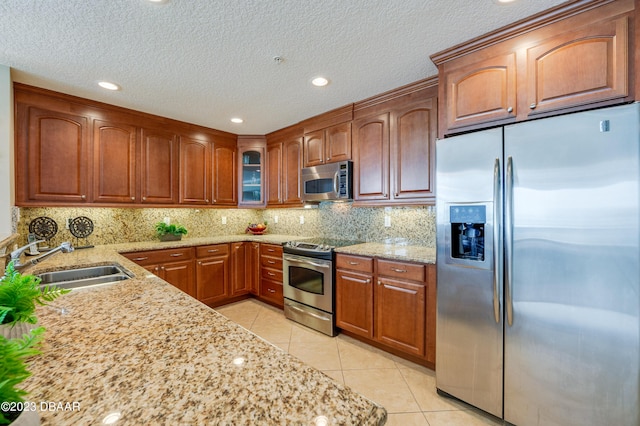 3801 S Atlantic Ave Unit 303, Daytona Beach Shores, FL 32118 - kitchen featuring stainless steel appliances, a sink, light tile patterned floors, light stone counters, and recessed lighting