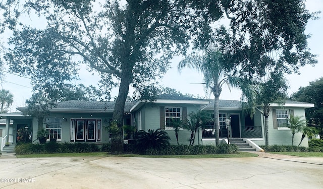 single story home featuring covered porch