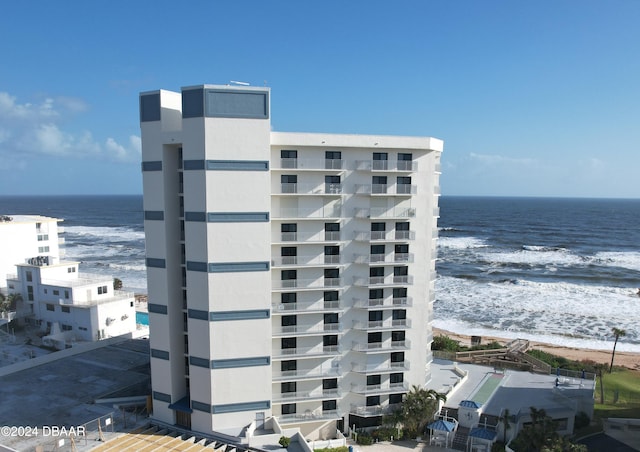 view of property with a beach view and a water view