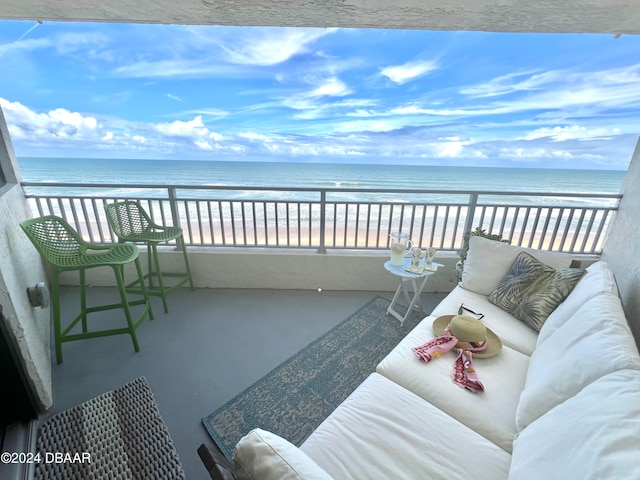 balcony featuring a water view and a view of the beach