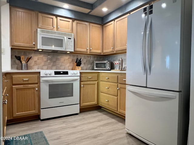 kitchen featuring light hardwood / wood-style floors, white appliances, and backsplash