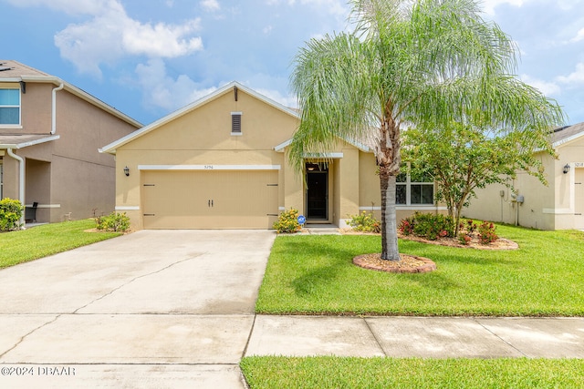 view of front of property with a garage and a front yard