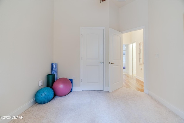 exercise room with light carpet