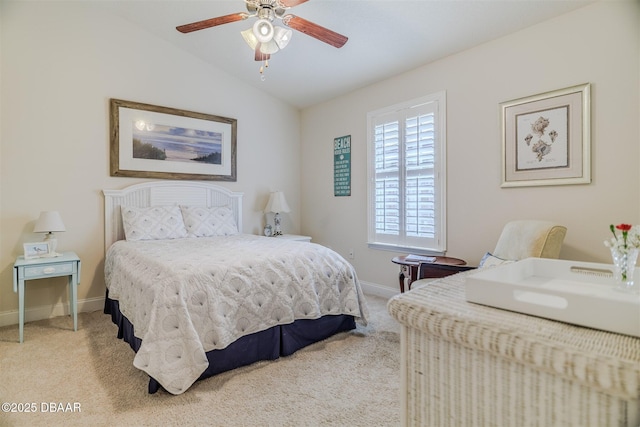 carpeted bedroom with ceiling fan and vaulted ceiling