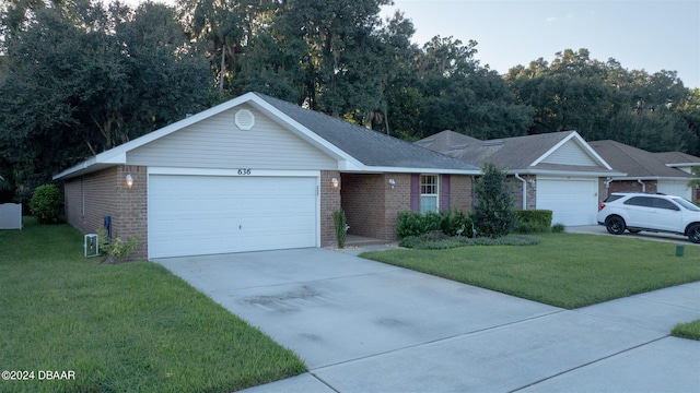 ranch-style home featuring a front lawn and a garage