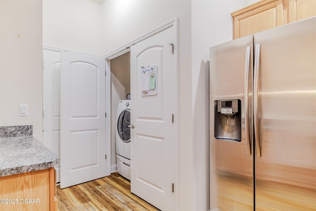 washroom with washer / clothes dryer and light hardwood / wood-style floors