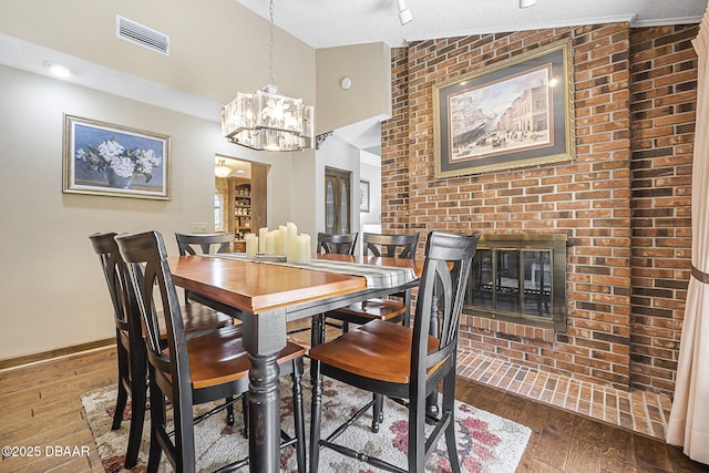 229 Riverbend Rd, Ormond Beach, FL 32174 - dining area featuring hardwood / wood-style flooring, a chandelier, baseboards, and a textured ceiling