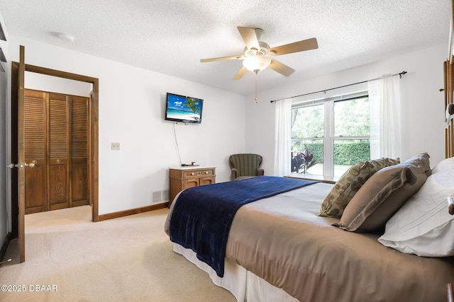 229 Riverbend Rd, Ormond Beach, FL 32174 - bedroom featuring light colored carpet, a textured ceiling, a ceiling fan, and baseboards
