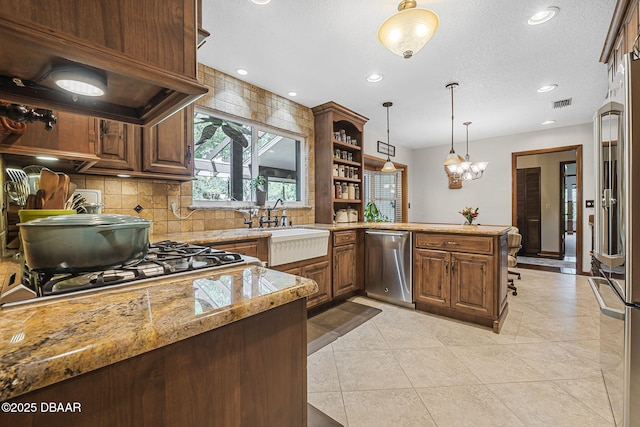 229 Riverbend Rd, Ormond Beach, FL 32174 - kitchen with appliances with stainless steel finishes, ventilation hood, tasteful backsplash, open shelves, and decorative light fixtures