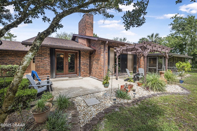 229 Riverbend Rd, Ormond Beach, FL 32174 - rear view of property featuring french doors, a pergola, brick siding, a chimney, and a patio area
