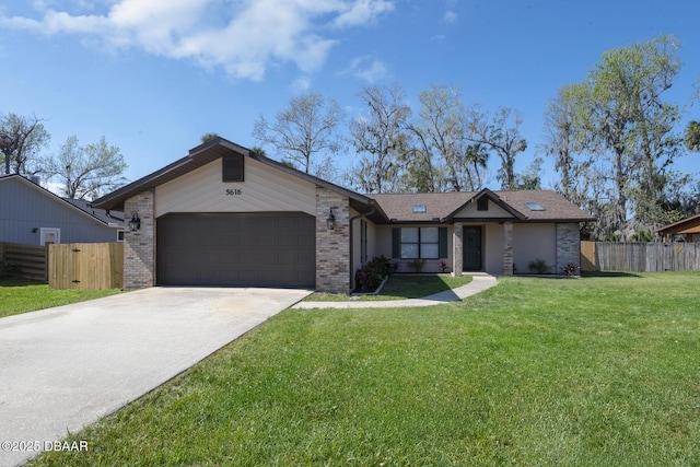 ranch-style house featuring a front lawn and a garage