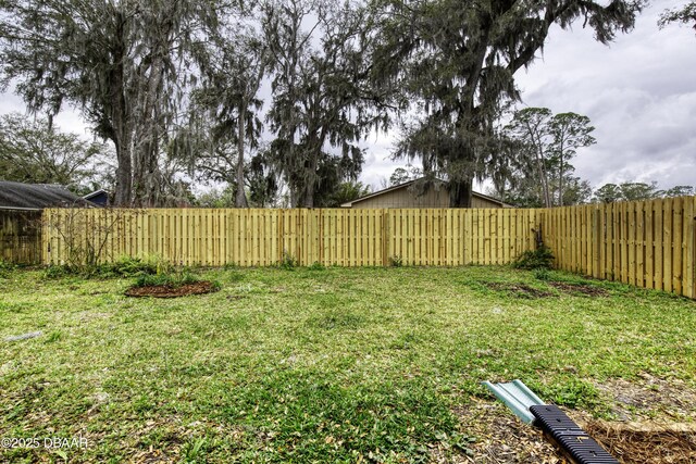 view of yard with a fenced backyard