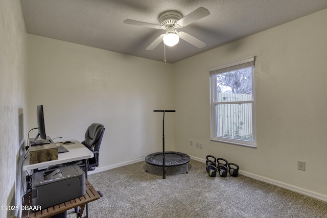 office featuring carpet, baseboards, and a textured ceiling