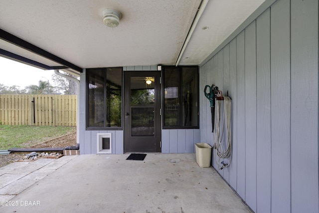 doorway to property featuring a patio area and fence