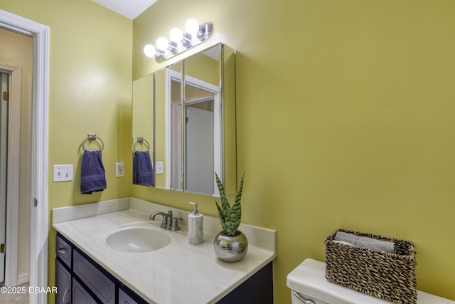 bathroom with toilet and vanity