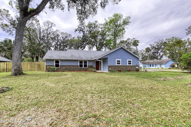 single story home with brick siding, a front lawn, and fence