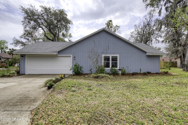 view of front of property with a front lawn, concrete driveway, and an attached garage