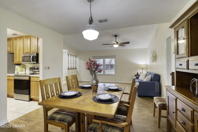 dining room with visible vents, baseboards, and ceiling fan