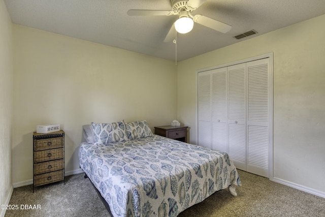 carpeted bedroom featuring visible vents, baseboards, a closet, and ceiling fan