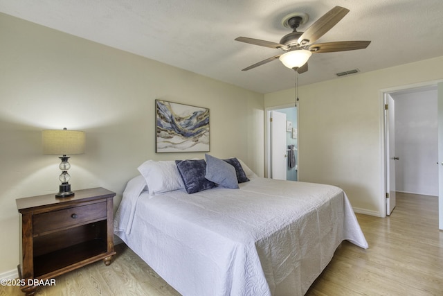 bedroom with a ceiling fan, light wood-style flooring, baseboards, and visible vents