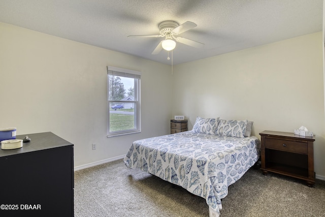 bedroom featuring ceiling fan, baseboards, carpet floors, and a textured ceiling