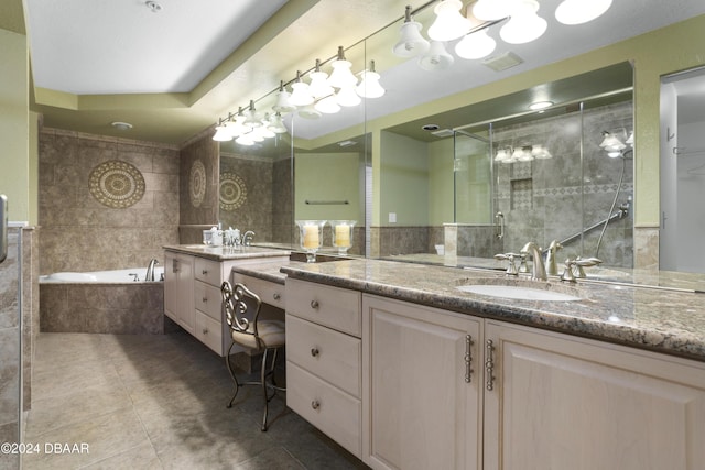 4621 S Atlantic Ave Ave Unit 7101, Ponce Inlet, FL 32127 - bathroom with tile patterned floors, vanity, a garden tub, a stall shower, and tile walls