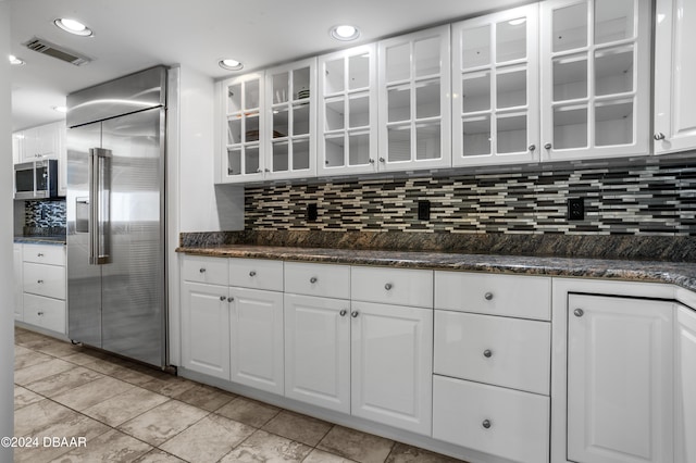 4621 S Atlantic Ave Ave Unit 7101, Ponce Inlet, FL 32127 - kitchen featuring appliances with stainless steel finishes, decorative backsplash, white cabinets, glass insert cabinets, and recessed lighting