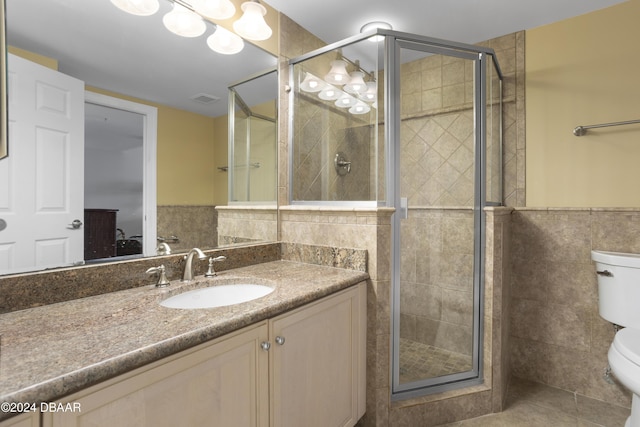4621 S Atlantic Ave Ave Unit 7101, Ponce Inlet, FL 32127 - bathroom featuring tile walls, a stall shower, vanity, and a wainscoted wall